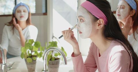 Mother and Daughter Bonding While Applying Facial Masks