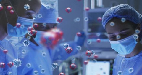 Surgical team operating in sterile or wearing masks and gowns with viral graphics and monitors