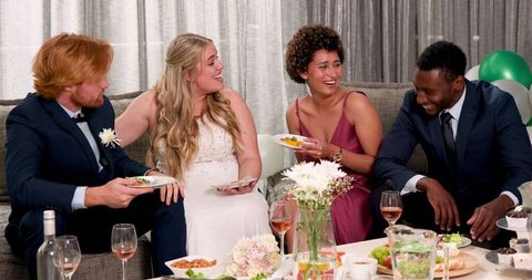 Multiracial Friends Celebrating a Joyful Wedding Reception Indoors