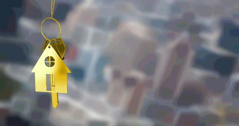 Golden house key with city view background for real estate inspirations