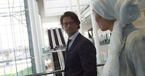 Business professionals standing in modern airport atrium