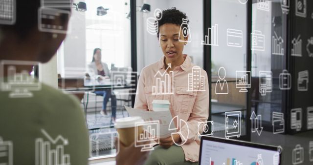Businesswoman presenting financial data to colleague in a modern office space. Various graphs and charts overlay, indicating business analysis. Suitable for use in articles and materials about business presentations, financial reports, corporate meetings, teamwork, and office environments.