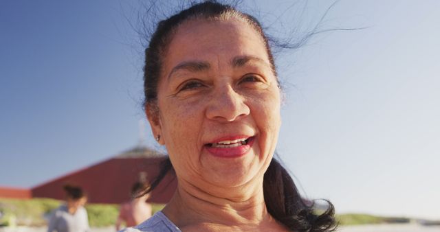 Smiling Elderly Woman at Beach on Sunny Day - Download Free Stock Images Pikwizard.com