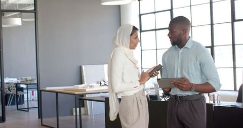 Business professionals utilizing technology in workplace
