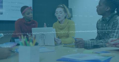 Collaborating team analyzing data visualization presenting ideas around conference table
