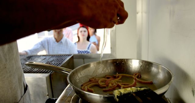 Chef Cooking Eels While People Watch From Restaurant Window - Download Free Stock Images Pikwizard.com