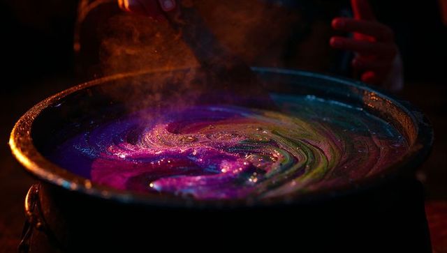 Enchanting alchemy crafting potion in steaming cauldron