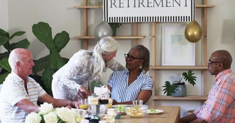 Senior friends celebrating retirement in cozy home gathering