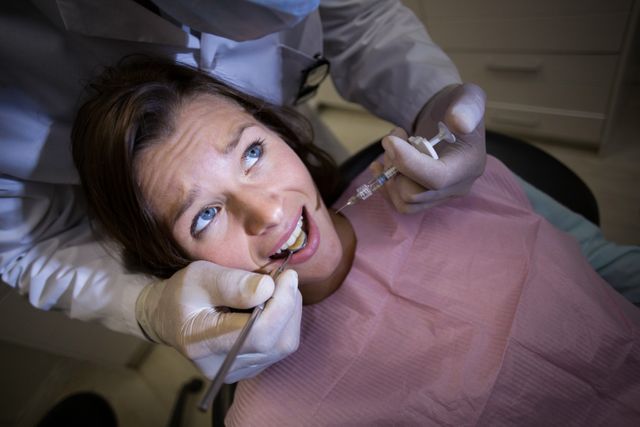 Dentist Injecting Anesthetic to Female Patient in Dental Clinic - Download Free Stock Photos Pikwizard.com
