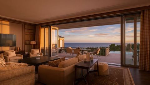 Luxury coastal living room opening to sunset deck and ocean view, contemporary retreat