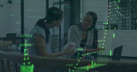 Colleagues discuss overlapping financial graphs in modern office