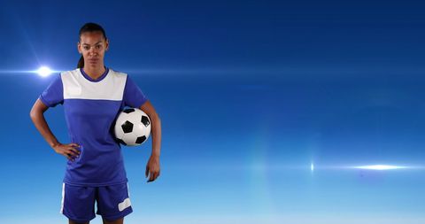 Confident Female Soccer Player Holding Ball Against Blue Sky - Download Free Stock Images Pikwizard.com