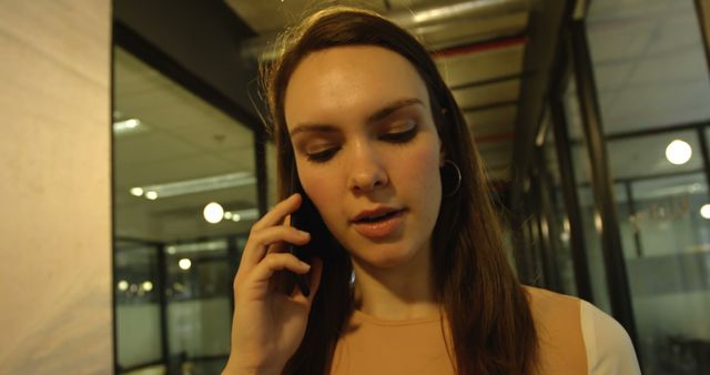 Woman Talking on Phone in Modern Office Corridor - Download Free Stock Images Pikwizard.com