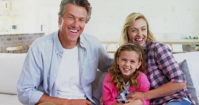 Happy Family Sitting on Couch Smiling at Camera - Download Free Stock Images Pikwizard.com