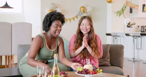 Happy Friends Celebrating Birthday with Cake and Candles