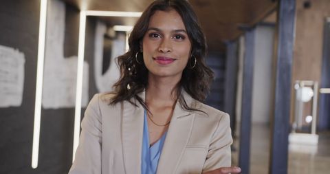 Confident biracial businesswoman standing in modern office