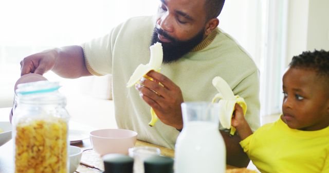 Father and Son Eating Breakfast Together at Dining Table - Download Free Stock Images Pikwizard.com