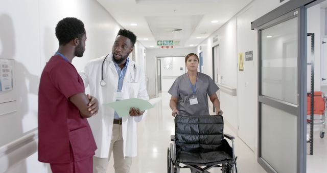 Medical Team Discussing Patient Care in Modern Hospital Corridor - Download Free Stock Images Pikwizard.com