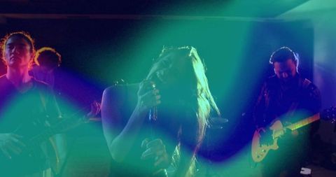 Female Singer Performing Energetic Live Concert with Band and Vibrant Lights