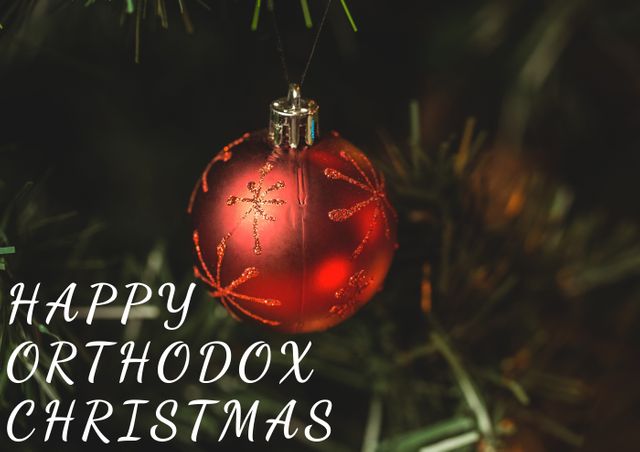 Red Christmas bauble hanging on tree conveys festive atmosphere of Orthodox Christmas. Perfect for greeting cards, social media posts, holiday promotions, and festive event announcements.