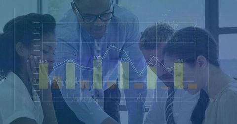 Diverse Business Team Analyzing Financial Data and Graphs on Laptop