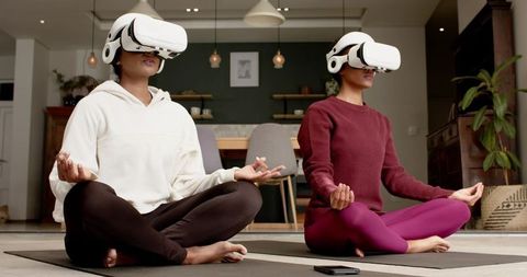Women meditating with vr headsets at home for digital calmness