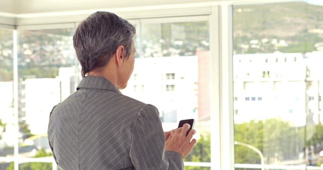 Senior Businesswoman Using Smartphone in Modern Office - Download Free Stock Images Pikwizard.com