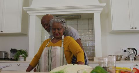 Senior Couple Enjoying Cooking in Kitchen Together