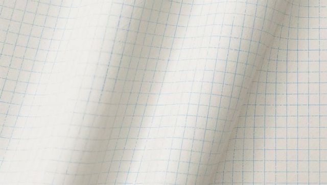 Folded squared graph paper texture showing blue grid lines and subtle creases