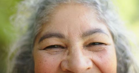 Senior Woman Smiling with Eyes Closed and Gray Hair
