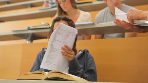 Student Joyfully Receiving Test Results in University Lecture Hall