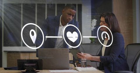 Colleagues collaborating over tablet and laptop with digital UI icons overlay for workflow