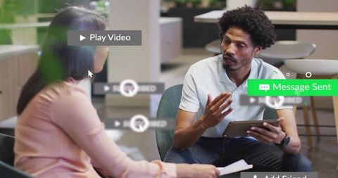 Man explaining on tablet during collaborative meeting with ui overlays, office lounge