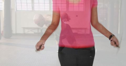 Woman skipping rope in gym with motion blur composition