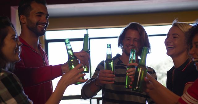 Diverse Friends Toasting with Beer Bottles at Party - Download Free Stock Images Pikwizard.com