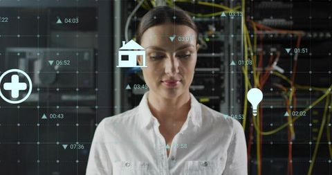 Female IT engineer monitoring server racks with holographic network HUD in datacenter