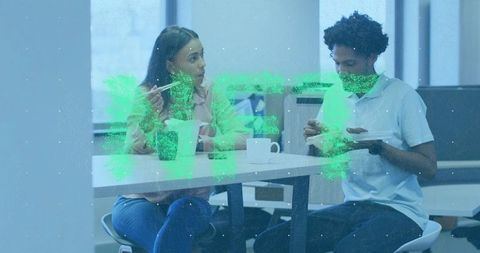 Colleagues enjoying lunch and coffee in office break area