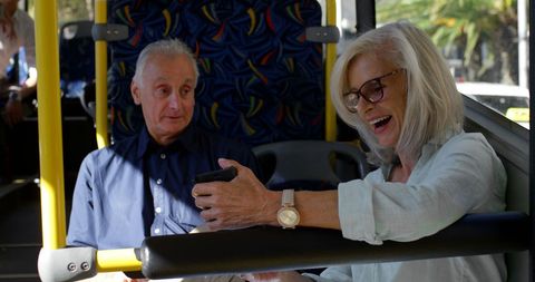 Joyful Senior Couple Enjoying Time on City Bus