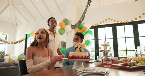 Celebrating Birthday with Joyful Friends in Sunlit Room