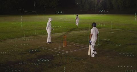 Cricket players training under floodlights with digital data overlay and analytics