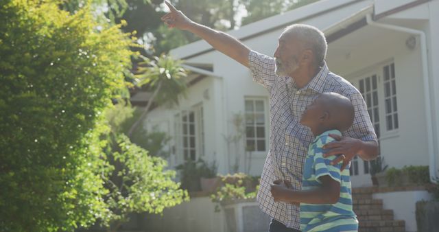 Grandfather and Grandson Pointing to Sky in Backyard - Download Free Stock Images Pikwizard.com