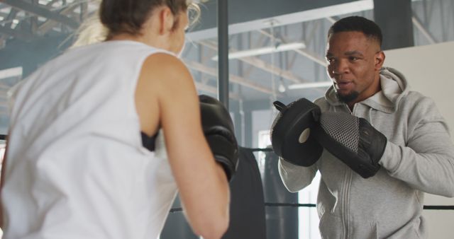 Boxing Trainer Instructing Female Athlete in Gym - Download Free Stock Images Pikwizard.com