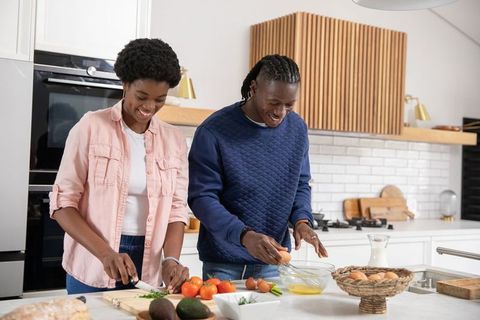 Couple Enjoys Preparing Breakfast in Modern Kitchen