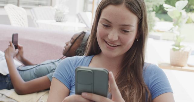 Teenage Girls Enjoying Smartphones and Relaxing Together - Download Free Stock Images Pikwizard.com