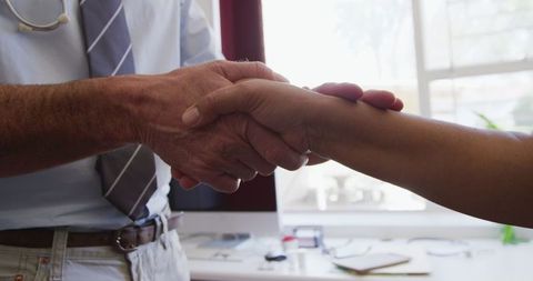 Doctor Comforting Elderly Patient in Medical Office