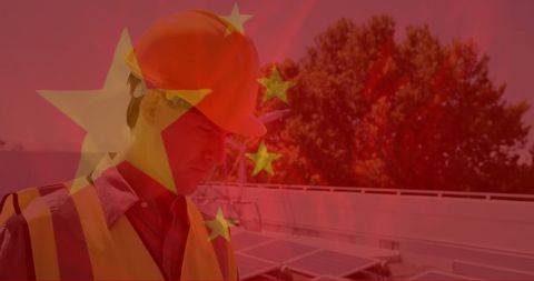 Construction Worker Focus Outdoor Project with Chinese Flag and Solar Panels - Download Free Stock Images Pikwizard.com