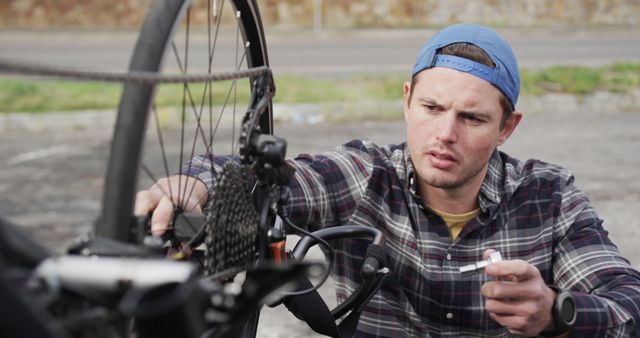 Young Male Cyclist Repairing Bicycle Outdoors on Sunny Day - Download Free Stock Images Pikwizard.com