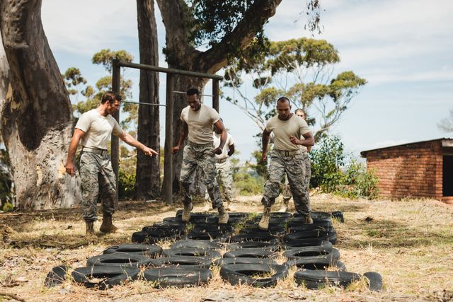Trainer giving training to military soldiers at boot camp