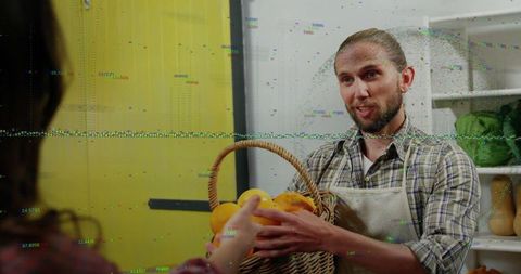 Friendly market vendor handing fresh produce basket of oranges