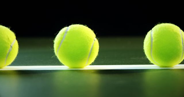 Three Tennis Balls in a Line on Black Background - Download Free Stock Images Pikwizard.com